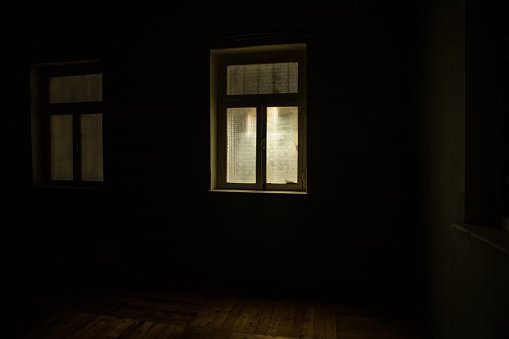 Night scene of moon seen through the window from dark room. Realistic dollhouse miniature decorated. Moonlight inside dark room