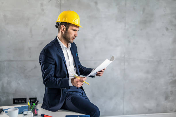 istock Mid adult architect working in the office. 1386984448