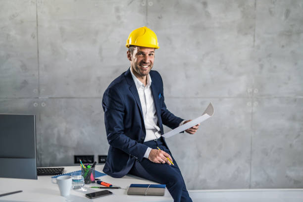 Happy mid adult architect working in the office. stock photo
