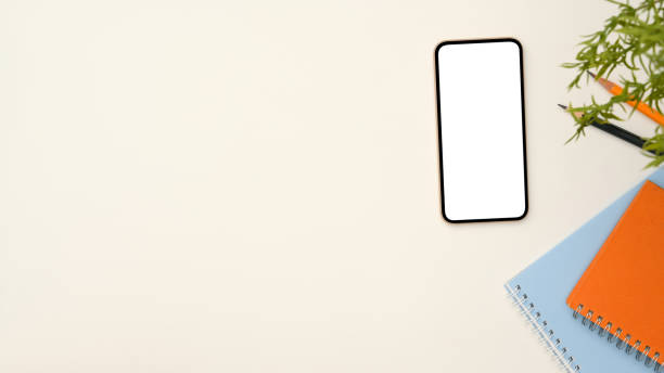 istock Minimal white workspace background with smartphone mockup and copy space 1386985932