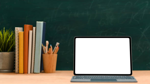 istock Education space, Laptop computer mockup against green chalkboard background. 1386985958