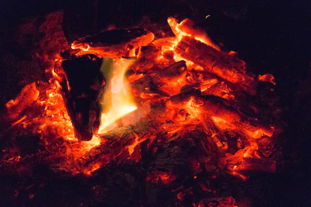 istock A dying bonfire ready for snuffing on black background. 1386986942