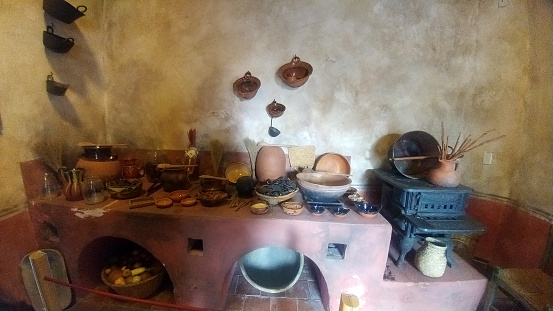 Rustic Mexican kitchen of a house in poverty with clay pots and pans, a wood stove in Mexico