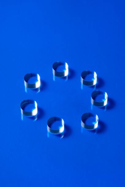 istock Transparent cylinder acrylic placed in a circle on a blue background 1386990087