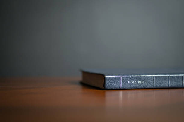 istock Holy Bible on wood table. 1386990766