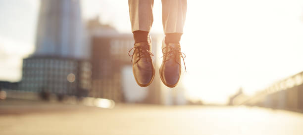 空中を飛び跳ねるビジネスマンのショット - men businessman jumping levitation ストックフォトと画像