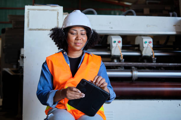istock Female engineer worker quality control inspects by tablet at a paper factory. 1386993925