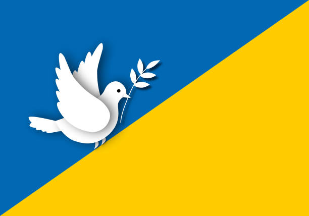 istock Paper white dove or pigeon carrying olive branch flying on Ukrainian flag background, Concept for peace and stop the war. 1386997993