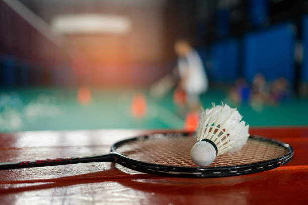 istock Badminton shuttlecock and racket with blur player background 1386999130