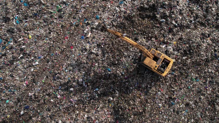 Garbage truck on a landfill dumping the garbage,pollution connect, garbage , social issues, recycling connect, plastic , landfill, dirty, industry, unhygienic connect