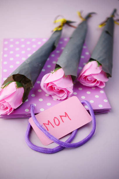 mother say concept with pink color rose flower and mom text on paper f mother day gift and flower on table.. Mother's Day stock pictures, royalty-free photos & images