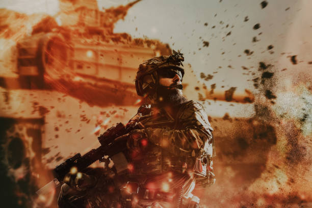 istock War concept. A bearded soldier in a special forces uniform fighting an enemy in a forest area. Selective focus 1387002272