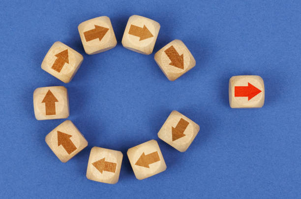 istock On a blue background in a circle are cubes with arrows, one cube with a red arrow outside the circle. 1387005840