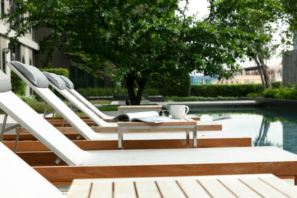istock Chaise lounges on side of  swimming pool 1387006140