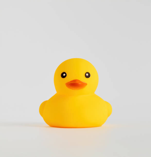 istock Yellow rubber duck toy on white background. 1387006910