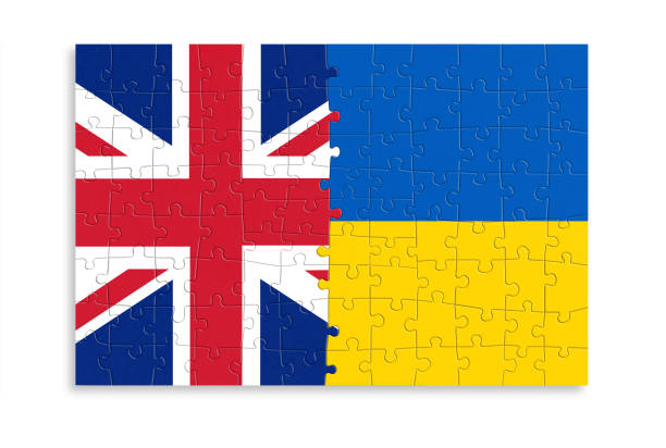 Puzzle made from UK and Ukraine flags. Relationship between United Kingdom and Ukraine stock photo