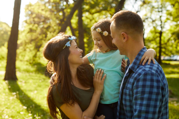 istock Young loving family having fun in the park 1387010874