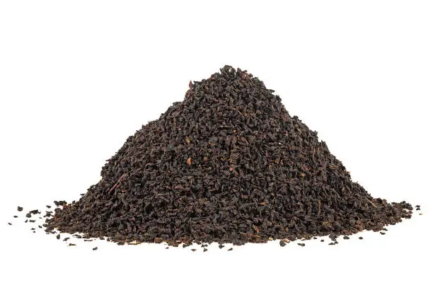 Dry black tea leaves isolated on a white background. Pile of Kenyan Black tea.