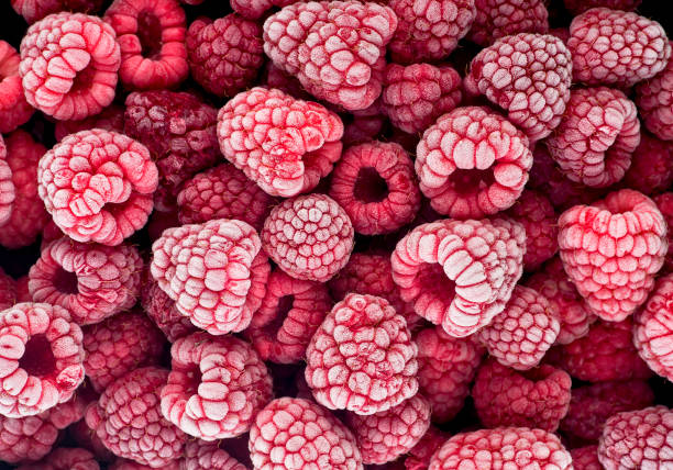 istock Frozen berries of raspberries, covered with hoarfrost as background. Top view. 1387013121