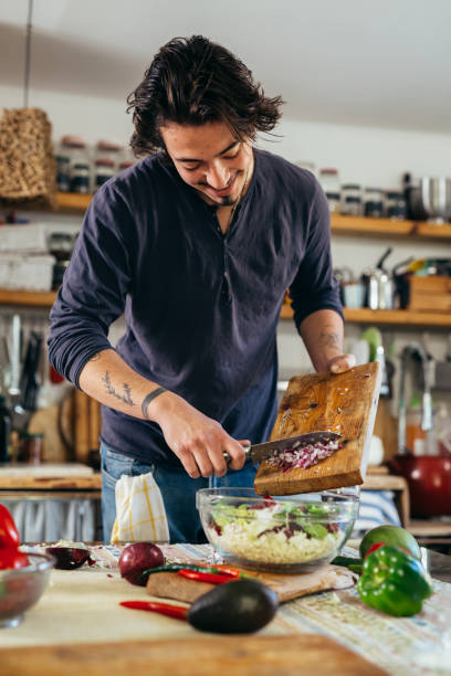 istock man preparing food in home kitchen 1387013146