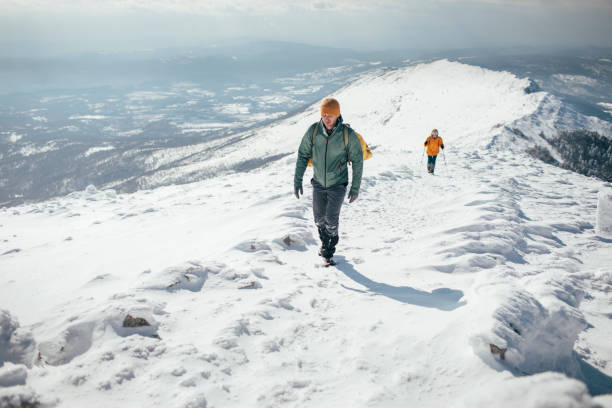 istock Hiking couple ascending snowy mountain 1387014703