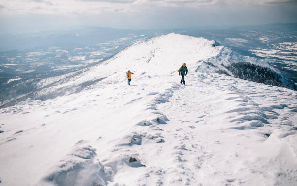 istock Hiking couple ascending snowy mountain 1387014712