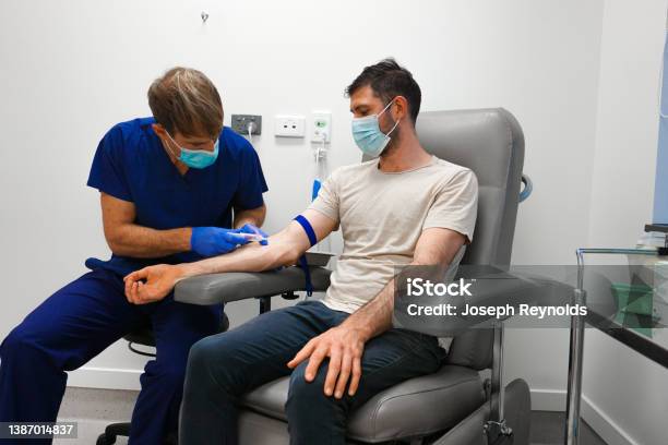 A Patient Having Blood Taken By A Healthcare Professional Stock Photo - Download Image Now