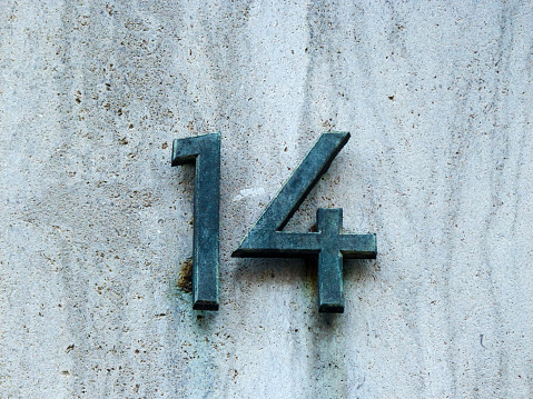 Metal house number on a wall
