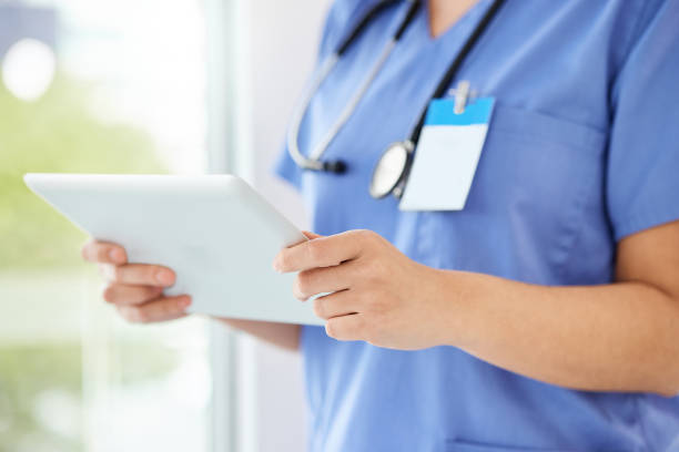 istock Shot of a unrecognizable nurse using a tablet in a office 1387016432