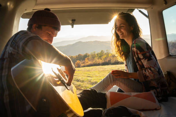 istock A young man romances his girlfriend, playing his guitar 1387017745