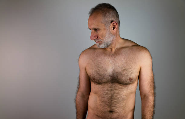 shirtless muscular mature man against white background - shirtless imagens e fotografias de stock