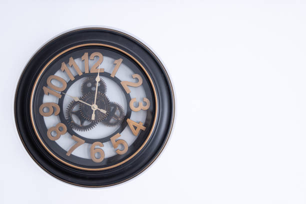 istock clock on the wall on a white background with space to the right 1387018909