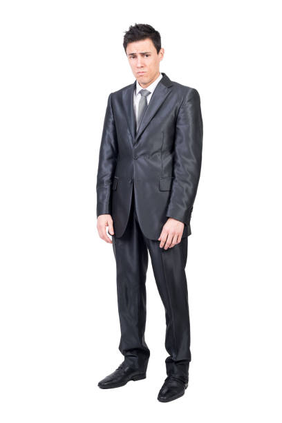 istock Upset young man in classy suit looking at camera 1387019188