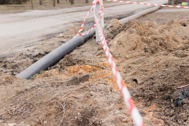 istock Plastic pipes in the ground during construction on the street 1387019898