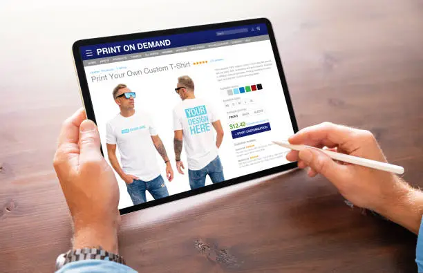 Man creating custom design t-shirt on print on demand service website