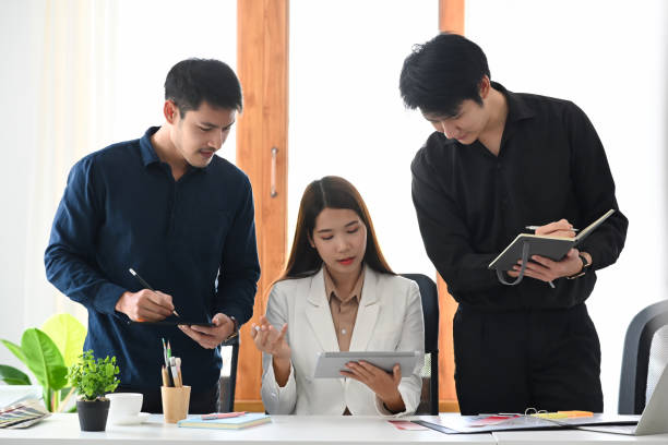 istock Group of interior designer collaborating on a new project at creative office. 1387024997