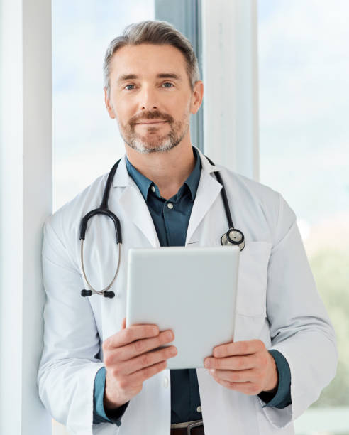 istock Shot of a mature doctor using a tablet in a office 1387028911