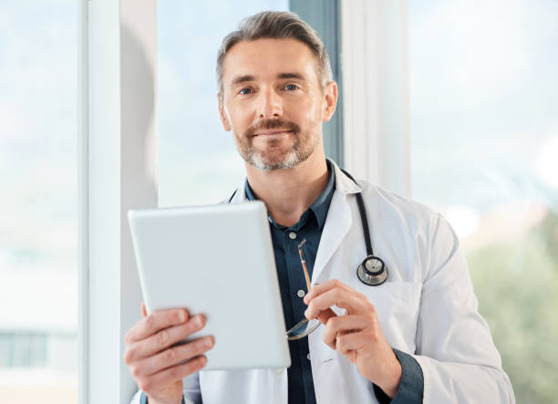 istock Shot of a mature doctor using a tablet in a office 1387028923