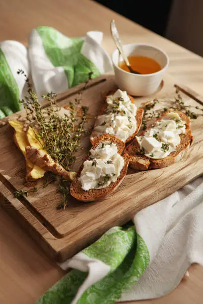 Tasty breakfast. Bruschetta with butter or cheese on wooden board. Appetizer or snack, antipasto. Delicious food