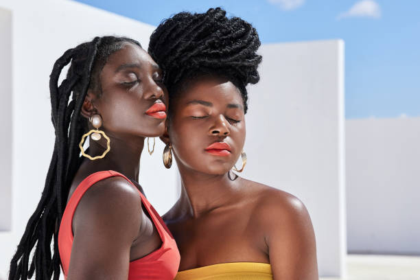 Cropped shot of two attractive young women posing on a rooftop outdoors Bright and bold braids stock pictures, royalty-free photos & images