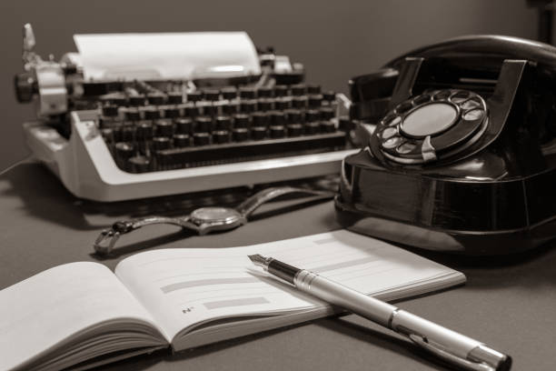 istock Checkbook with blank page. Retro concept with old phone, ink pen and typewriter. black and white 1387032516