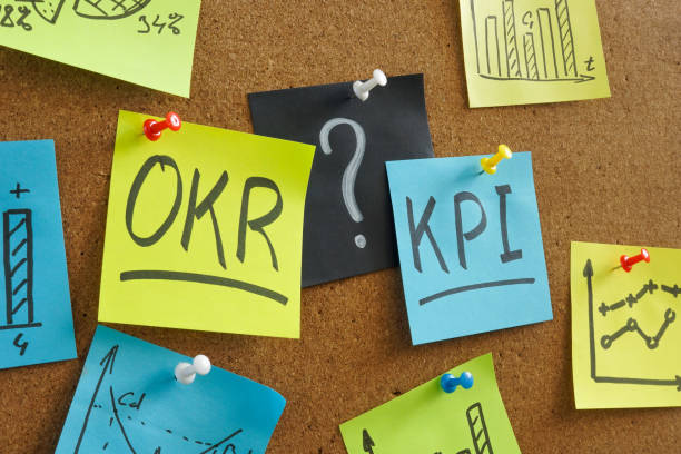 Memo sticks with OKR vs KPI words on the board. stock photo