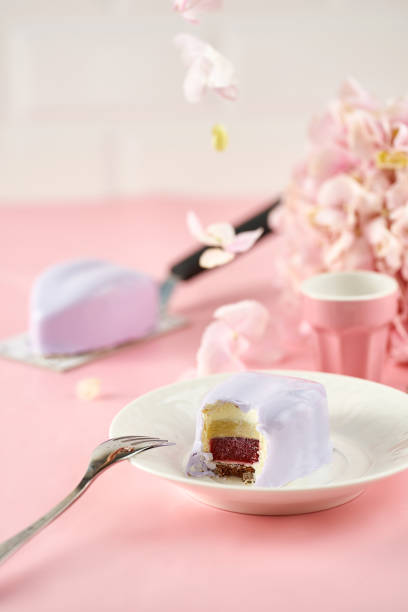 istock Mousse lavender heart-shaped cake on a pink background 1387033489