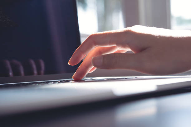 istock Business woman's hands working on laptop keyboard on office table, surfing the internet 1387033686