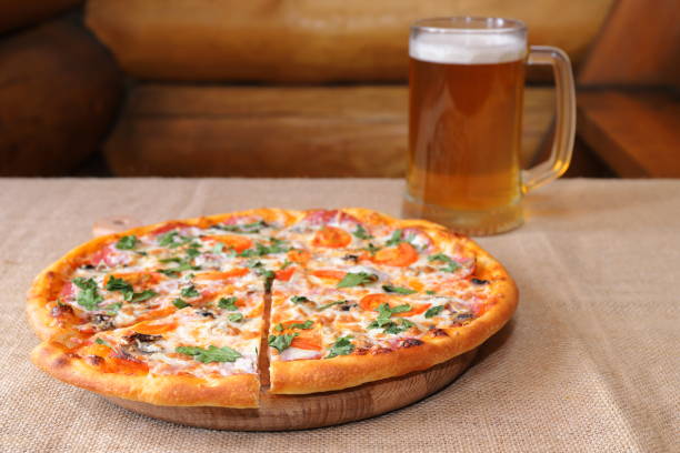 istock A pizza with a glass mug of beer, 1387034351