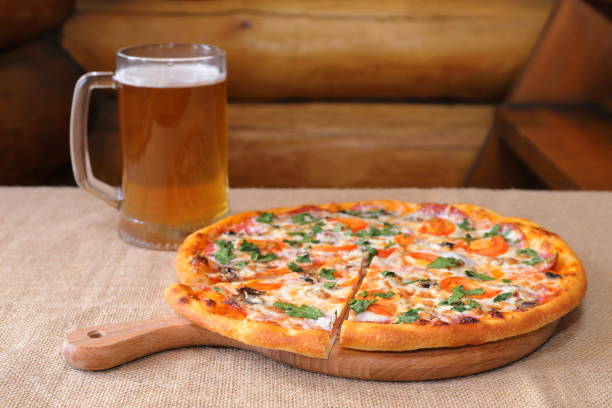 istock A pizza with a glass mug of beer, 1387034352