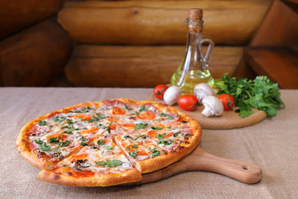 istock Traditional pizza and cutting board with products and ingredients. 1387034355
