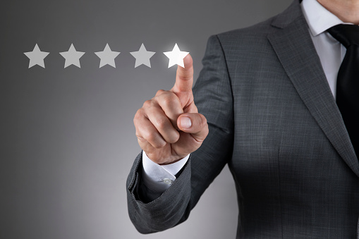 Businessman is giving five star symbol to increase rating of a  company