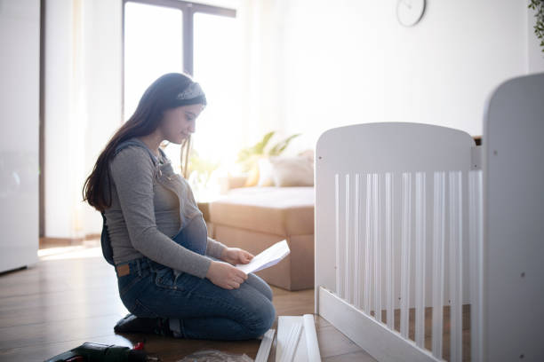 istock Preparing the crib for baby. 1387035122