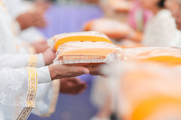 People give monk cloth in Thai ordination ceremony